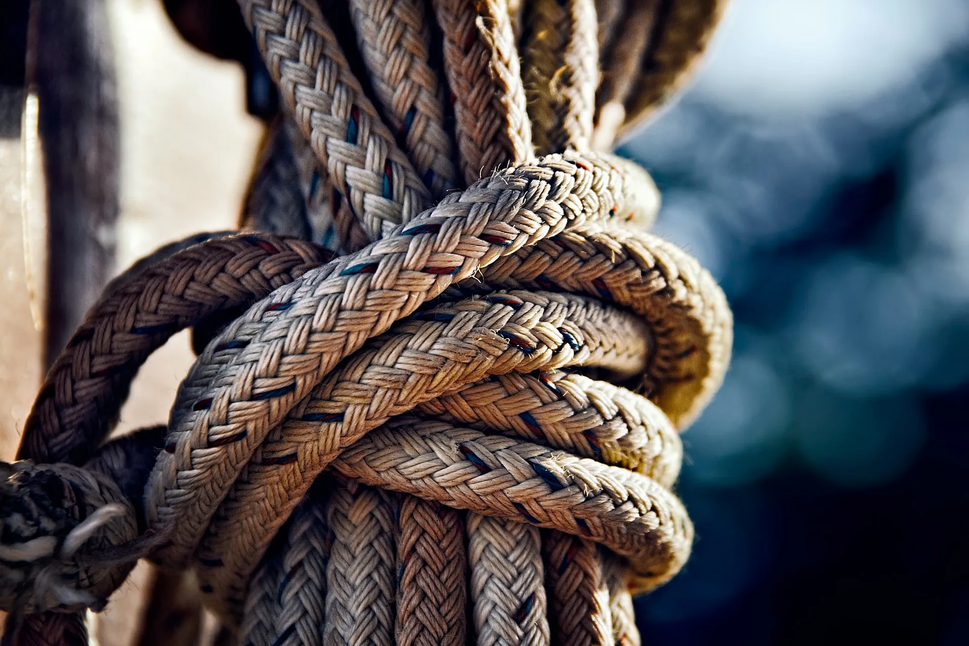 Braided mooring ropes coiled around a cleat, worn smooth by use