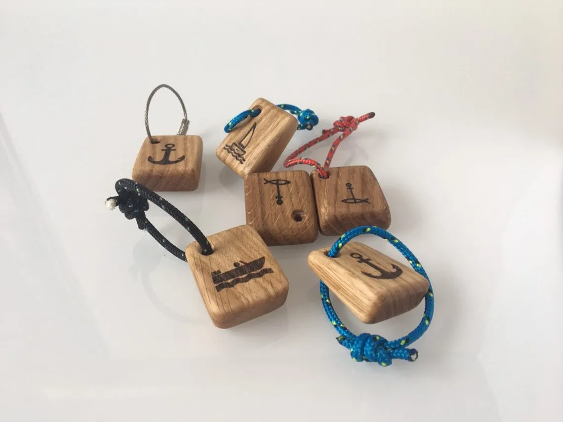 Several anchor keyrings laid out in a row with different cord options