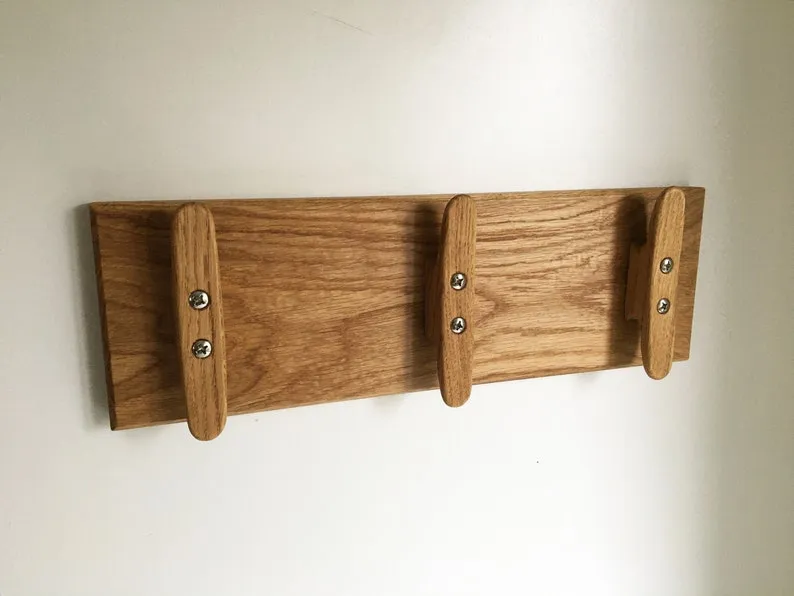 Stainless steel bolt heads set into the back of the oak mounting board