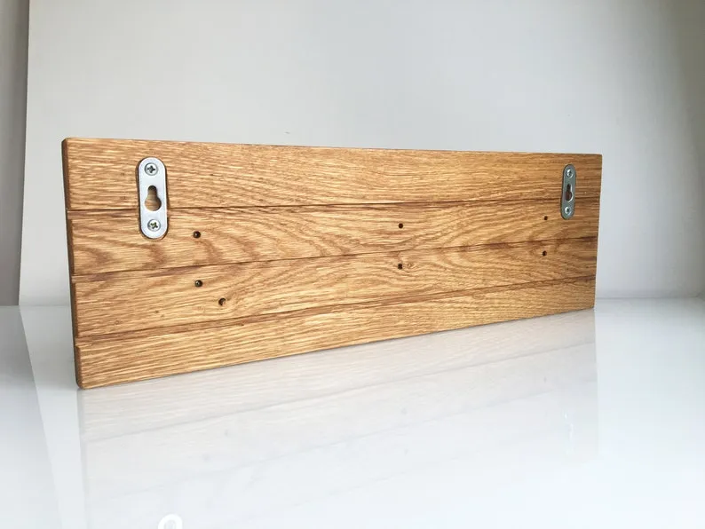 Angled view along the 43cm oak board showing its varnished sheen