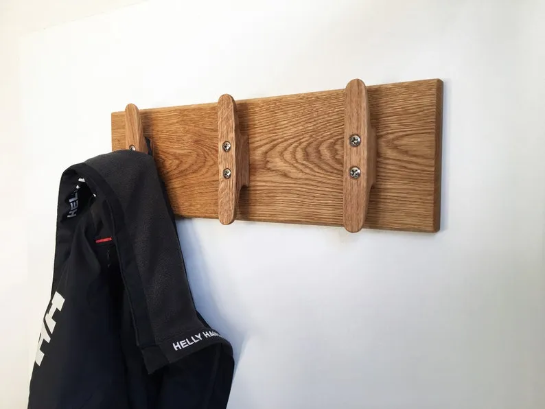Folded towel hanging over the middle cleat of the nautical rack