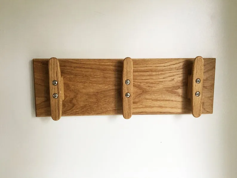 Coat rack photographed straight on against a plain pale background