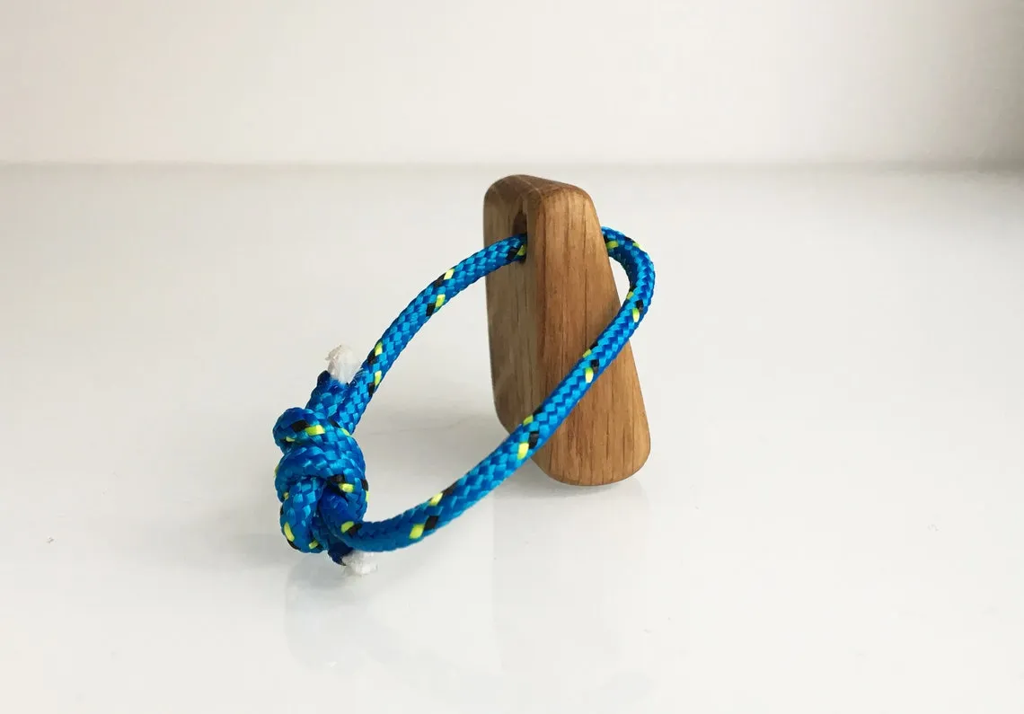 Keychain strung on blue yacht rope with the rope coiled beside it