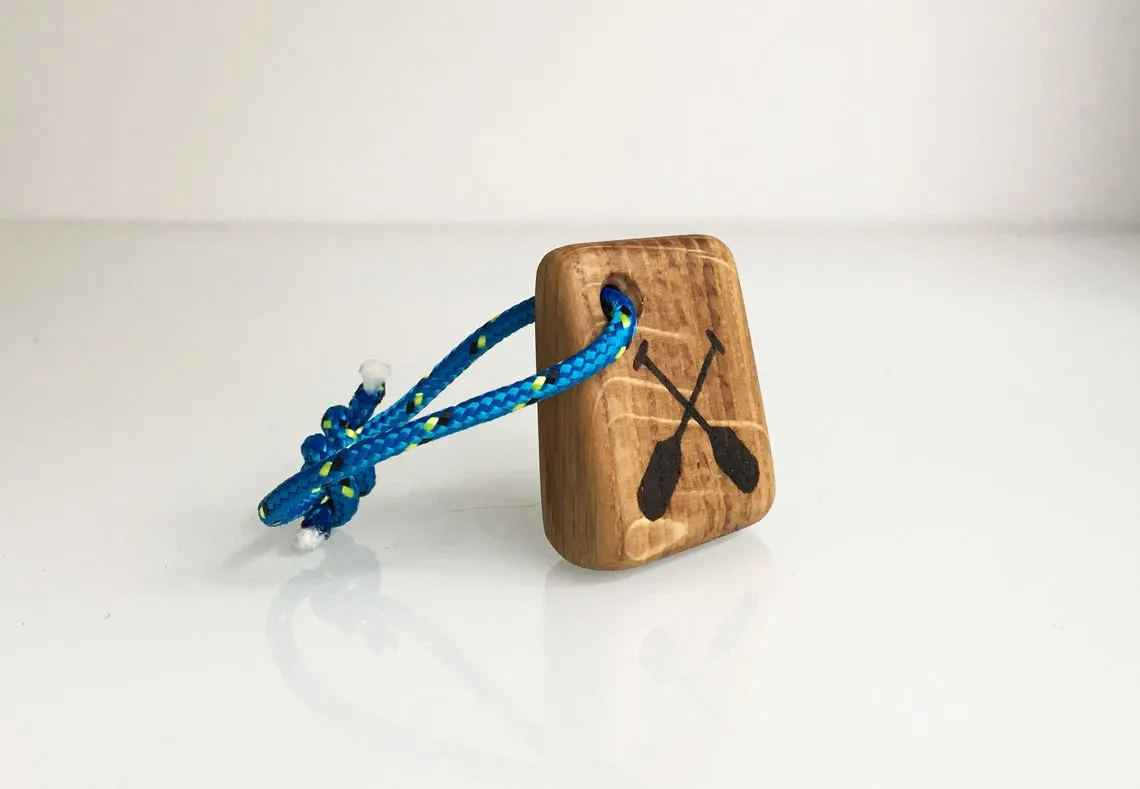 Grey rope version of the paddle keychain against a pale background