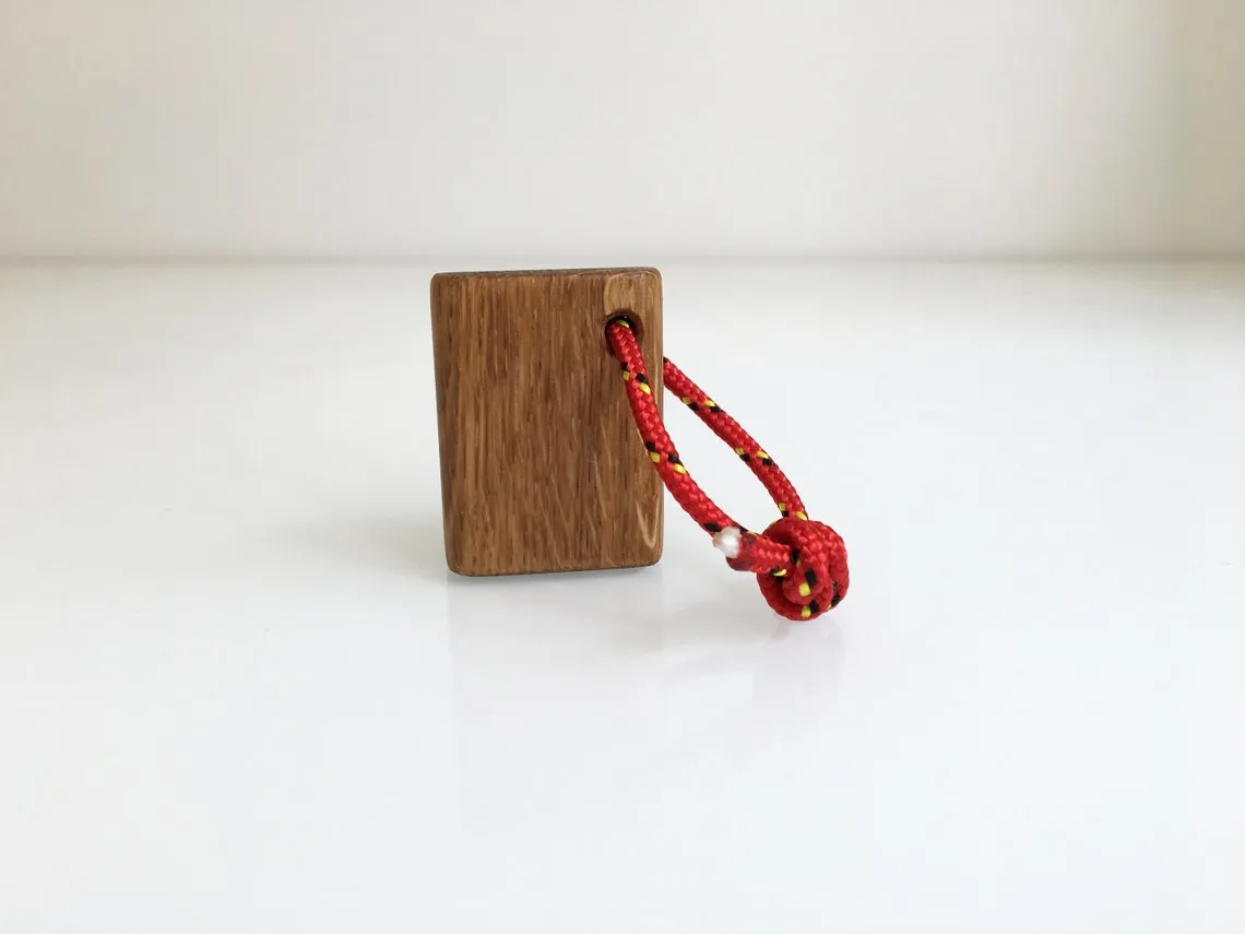Fish bone keychain resting in the palm of a hand
