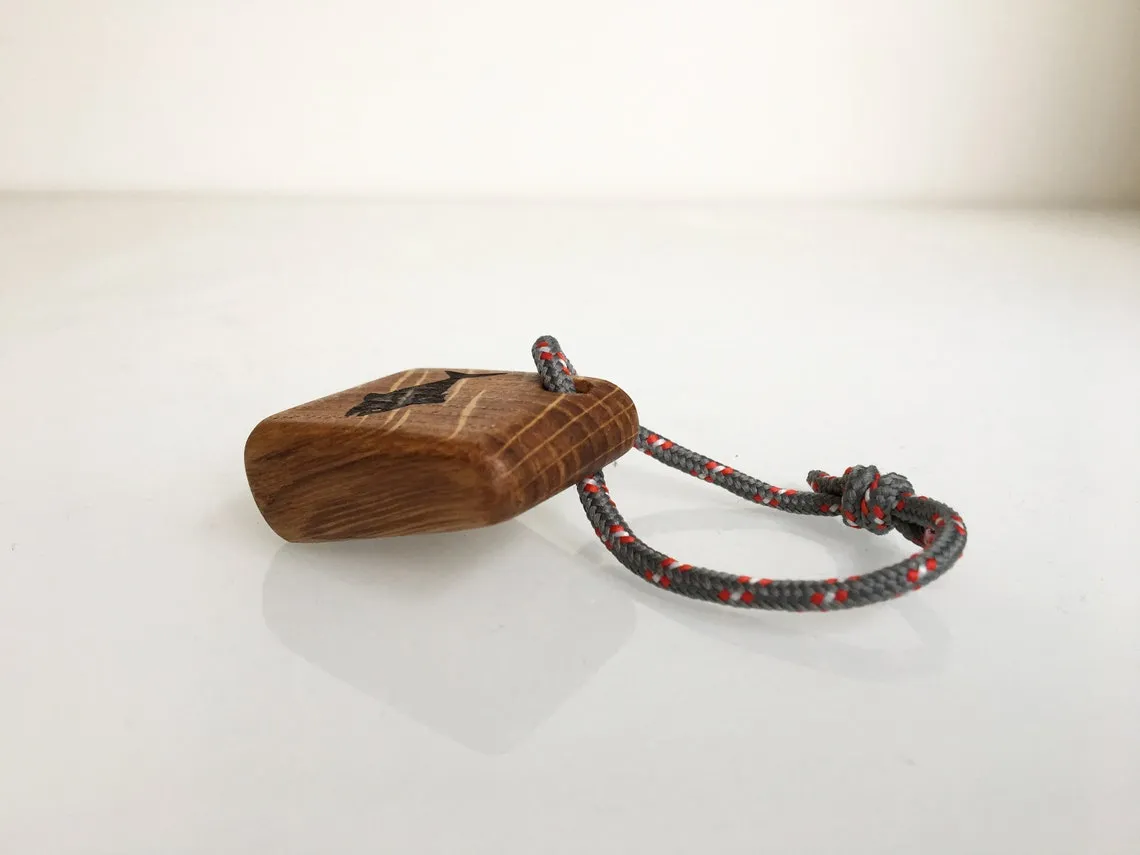 Blue yacht rope threaded through the oak tuna keychain