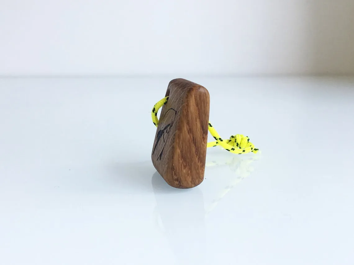 Fishing keychain resting on a loose coil of yacht rope
