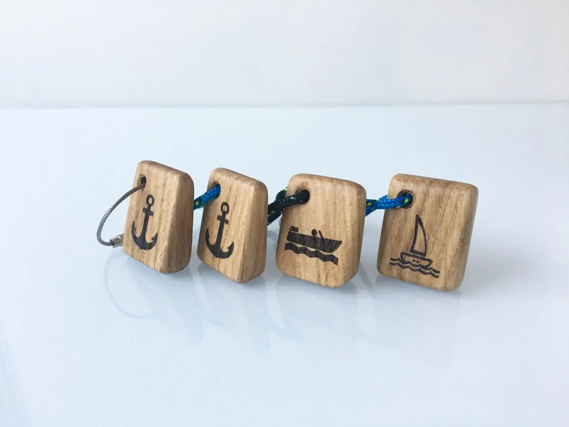 Seven fishing keychains laid out by rope colour