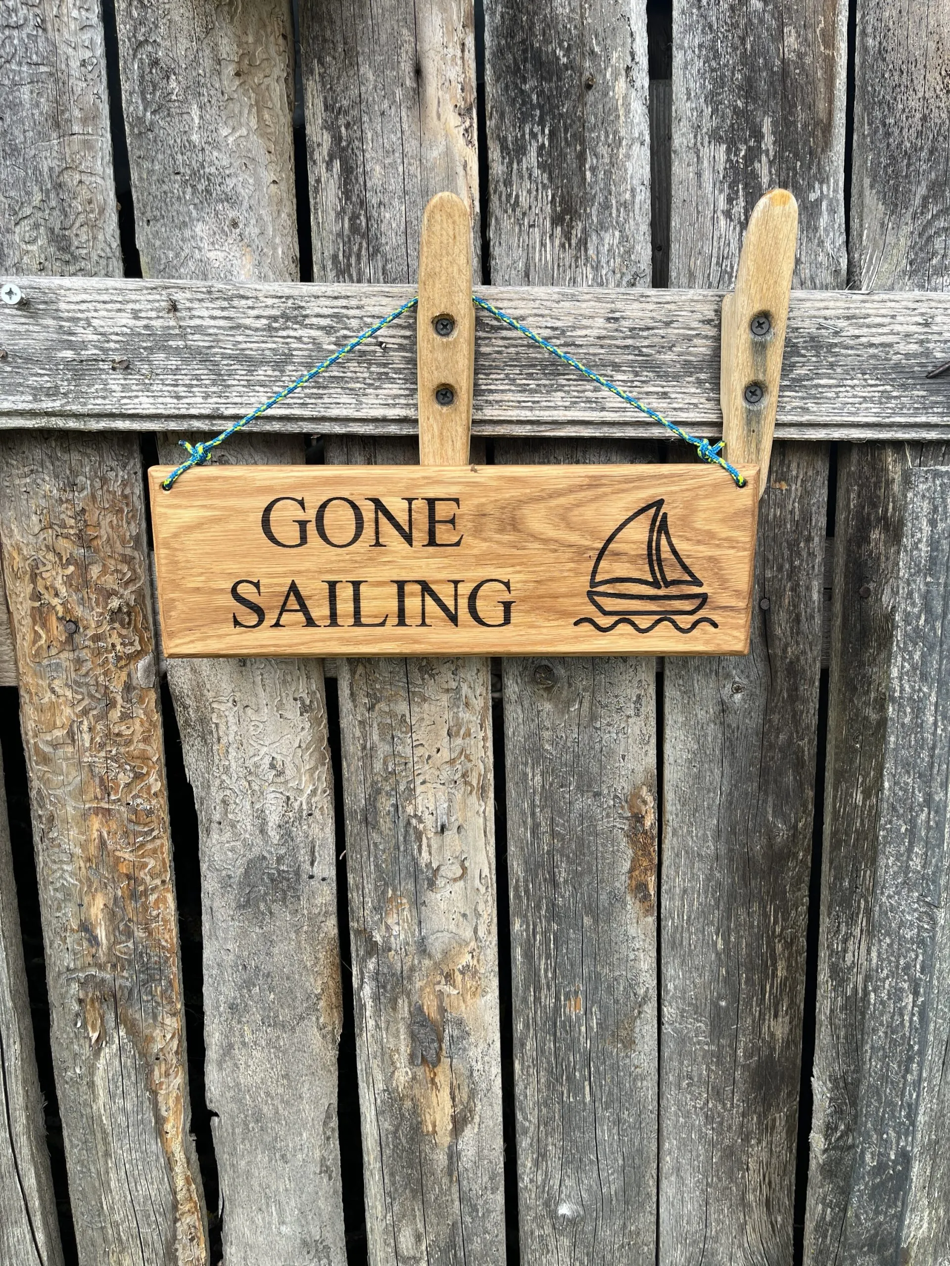 Sign hanging on a white door beside a brass handle