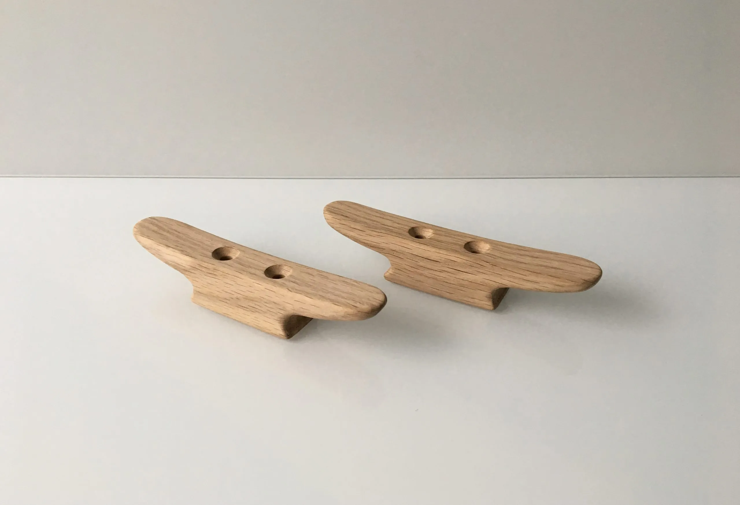 End grain and the two drilled mounting holes of an unfinished cleat
