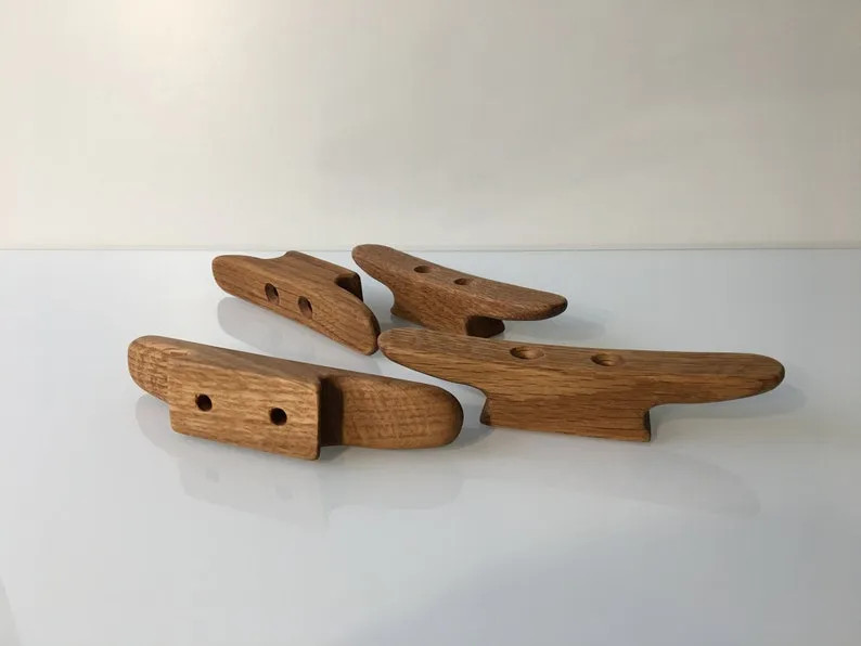 Both cleats laid on a tape measure showing the 140mm length