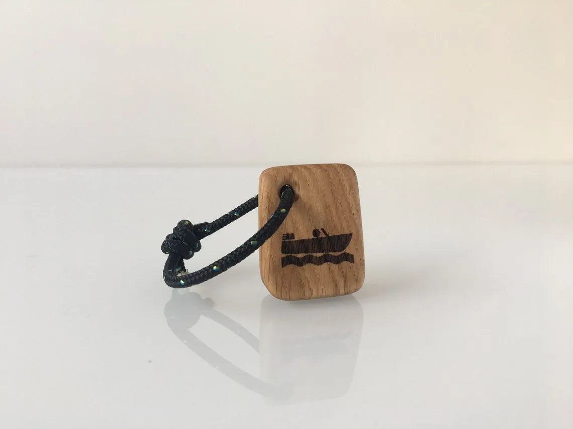 Keyring held in a palm, showing the small oiled oak block