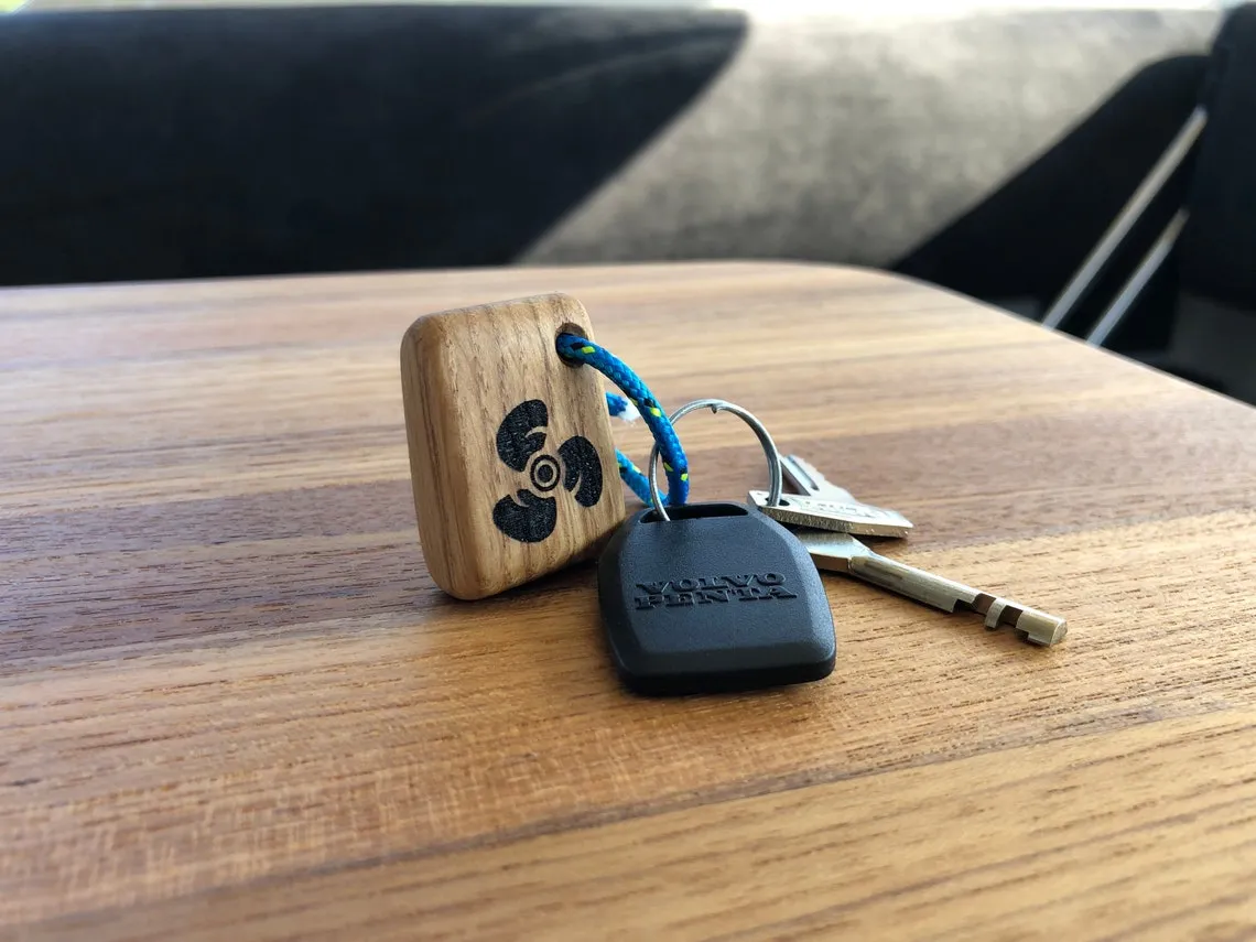 Warm tung oil sheen across the face of the propeller keychain