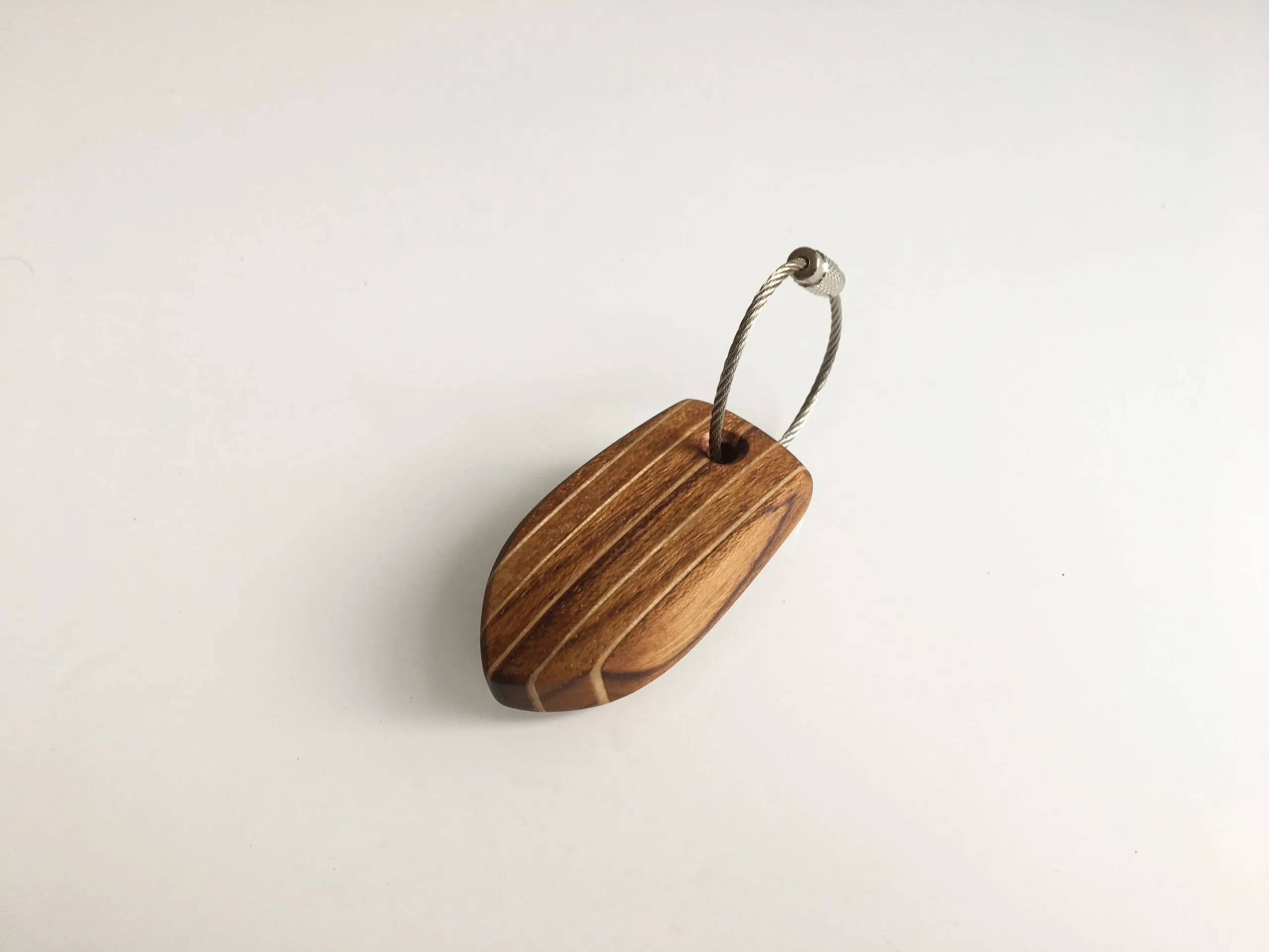 Keychain lying on the varnished deck of a classic boat