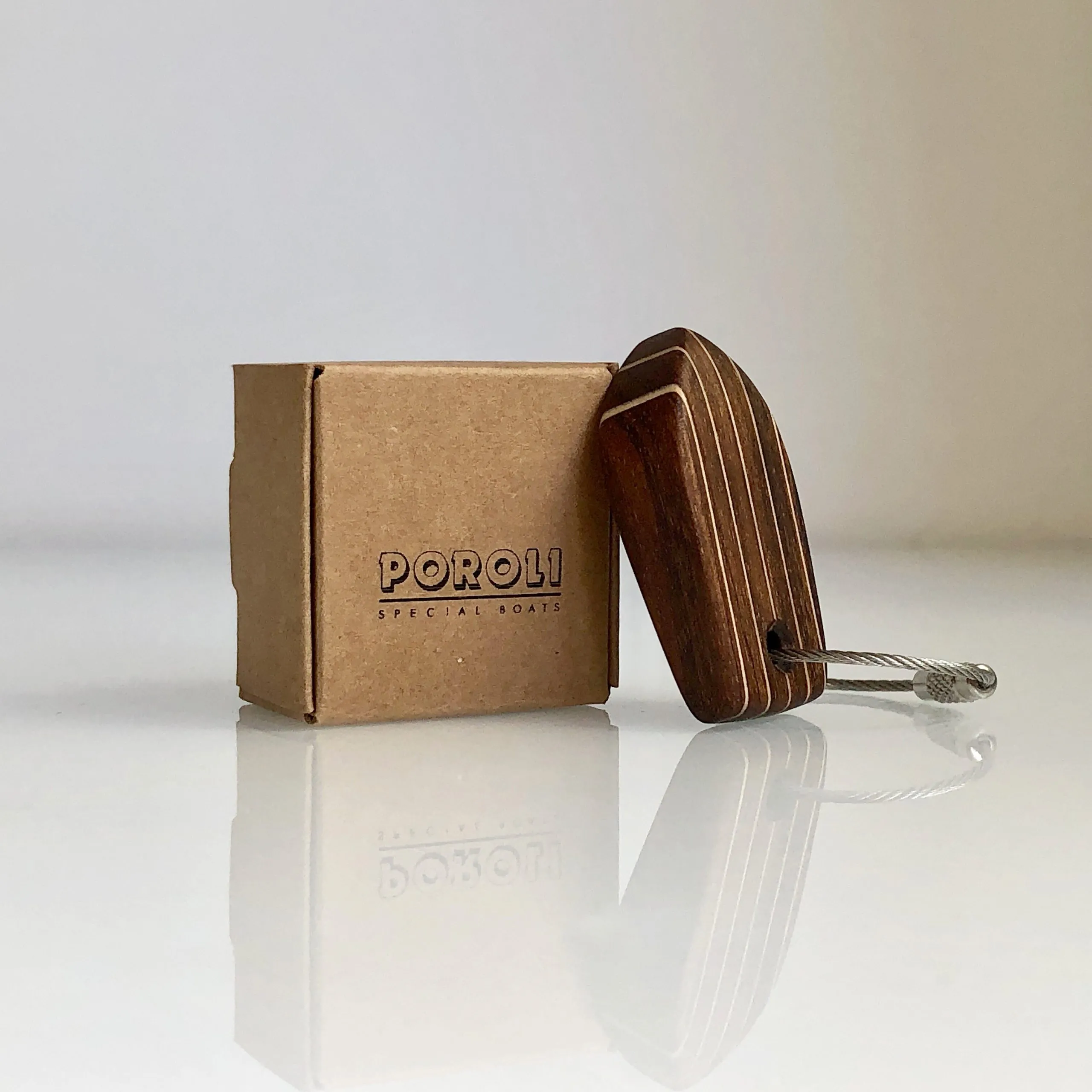 A deck-pattern keychain next to a printed presentation box