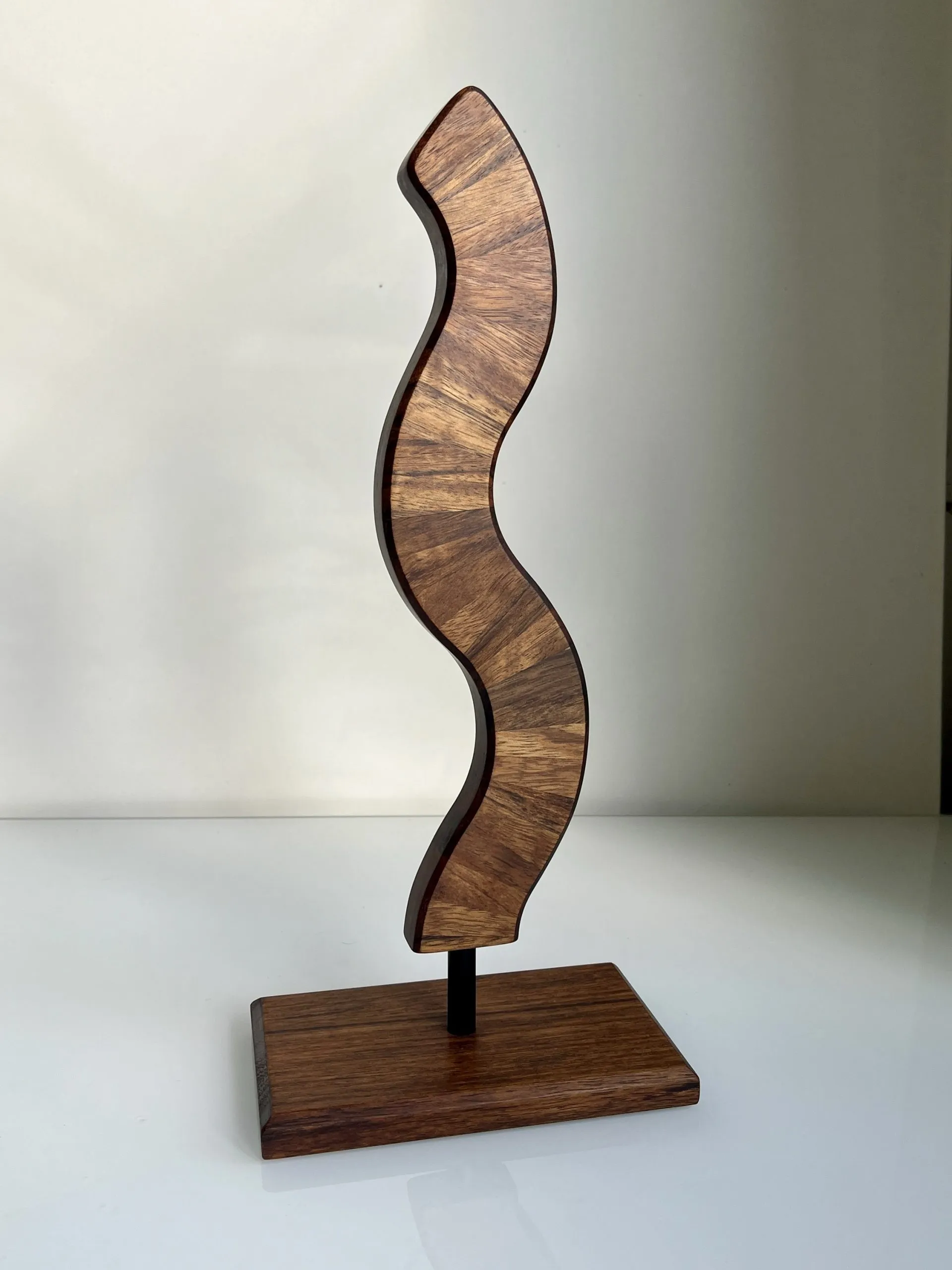 Slender teak Sea Weed sculpture standing upright on its wooden base