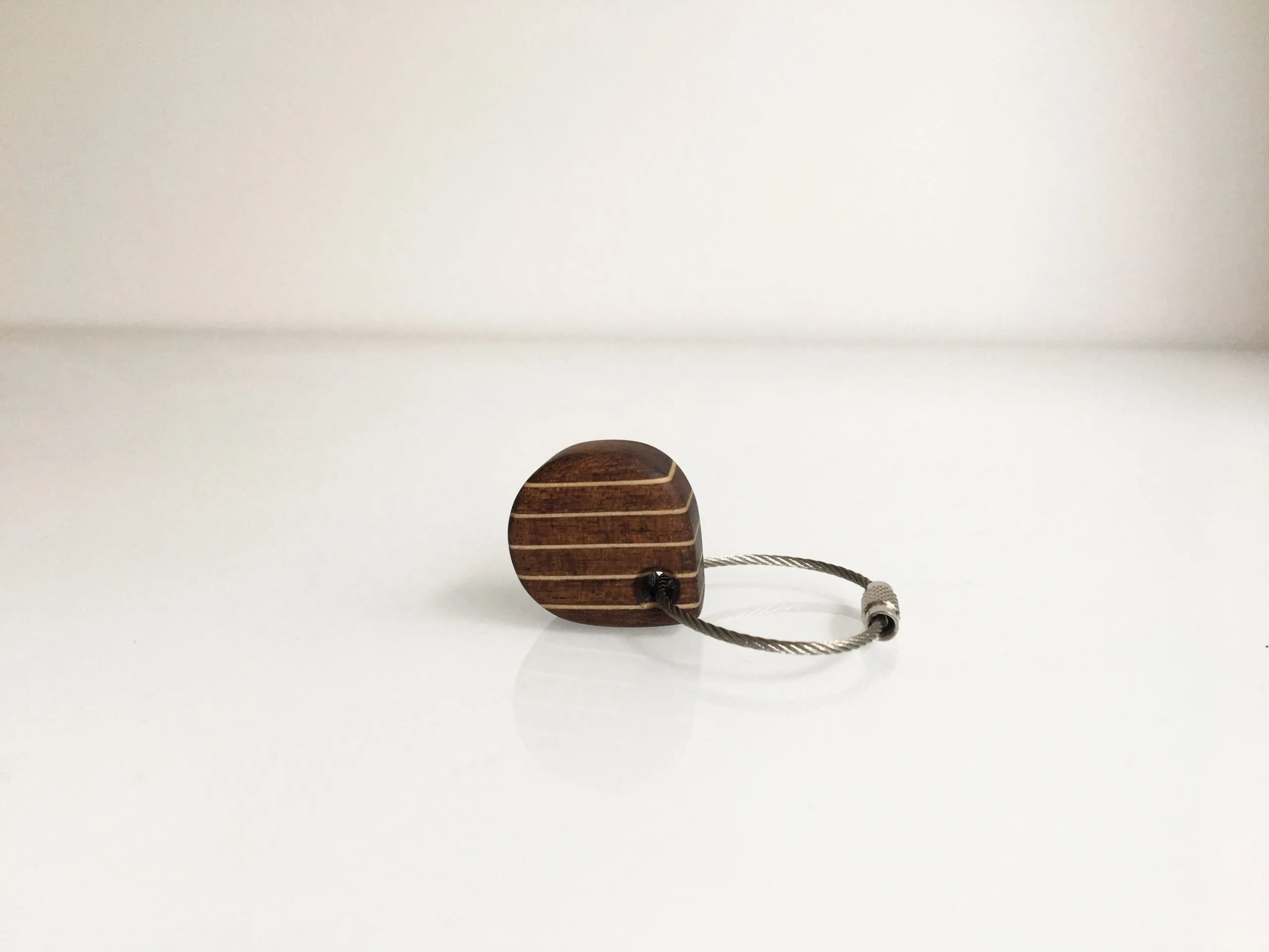 The deck pattern keychain held between finger and thumb