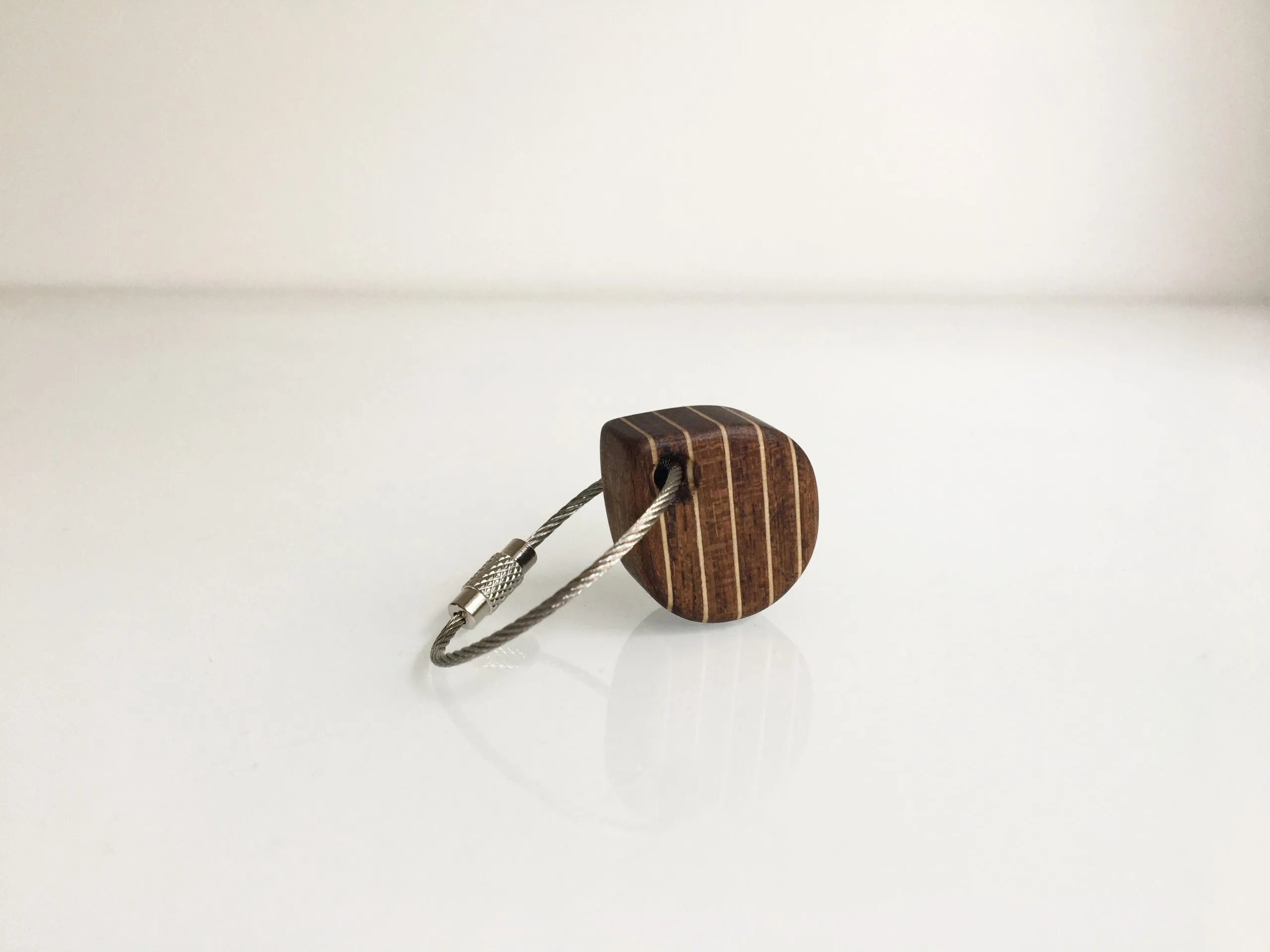 Stainless steel rope loop threaded through the small teak block