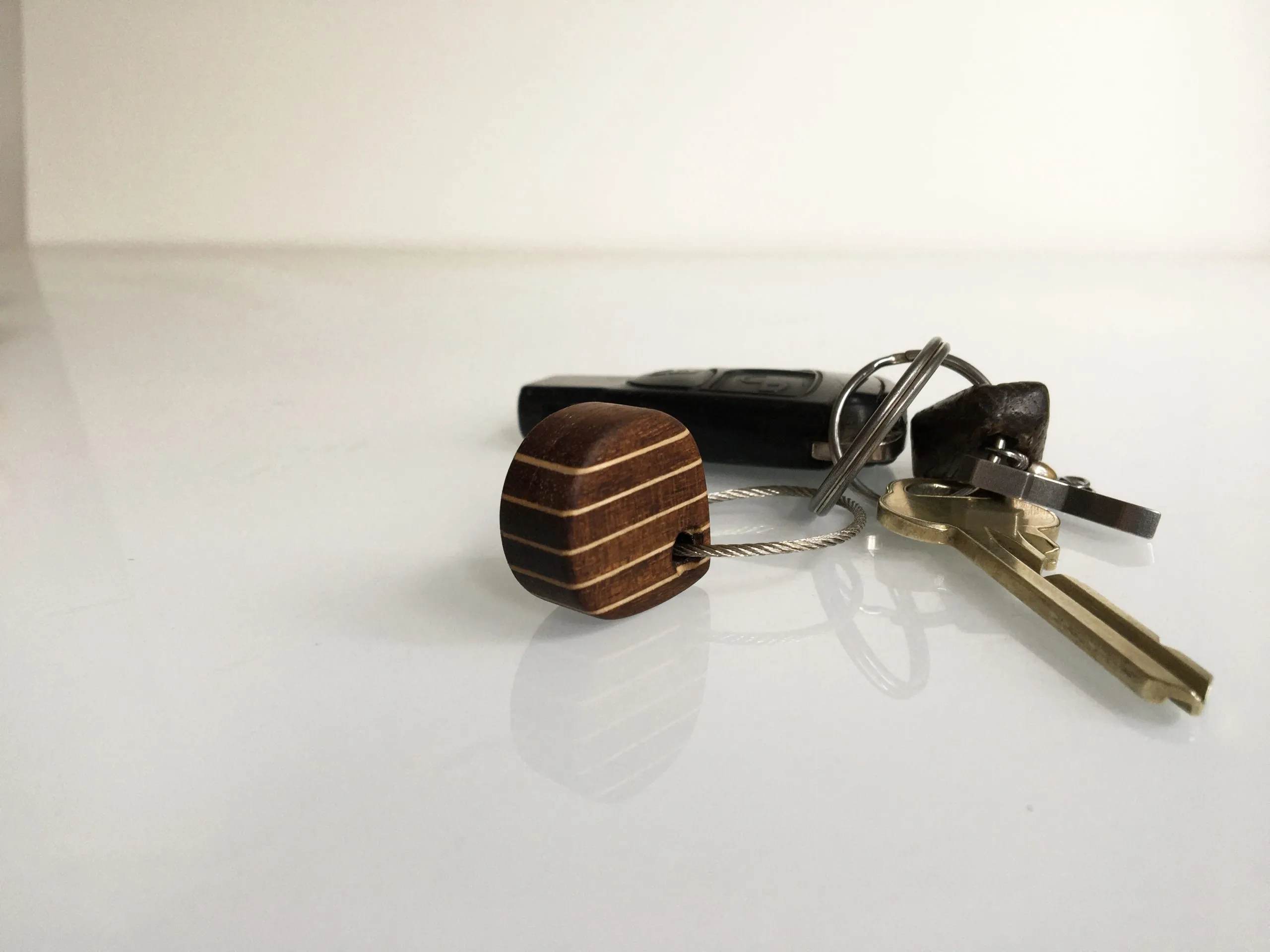 Deck style keychain resting on a coil of rope