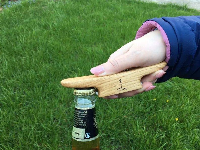 Oak boat cleat bottle opener on a weathered workshop bench