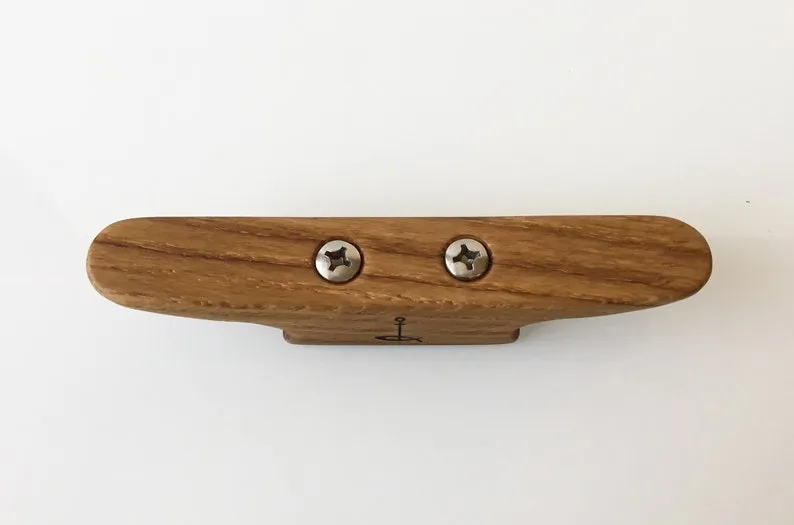 Both ends of the opener shown, each one able to open a bottle