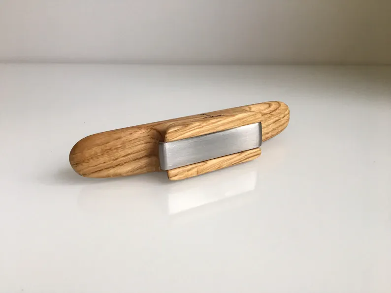 Soft light reflecting off the tung-oiled surface of the opener