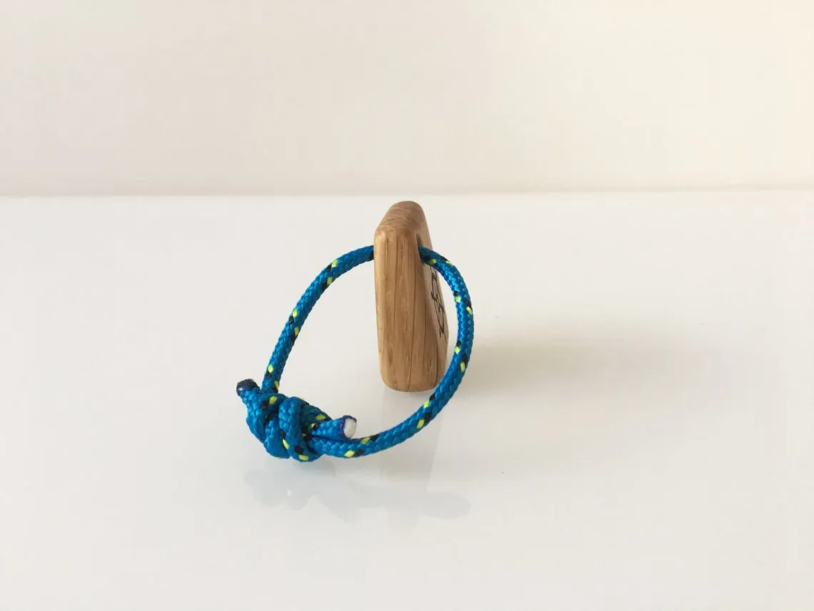 Steering wheel keyring lying on a paper chart beside dividers