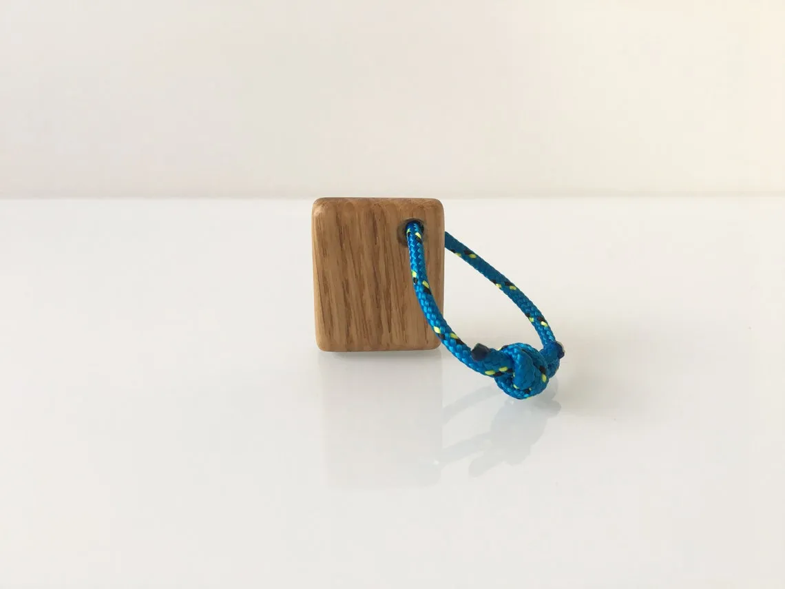 Keyring held in a hand, showing how small the oak block is