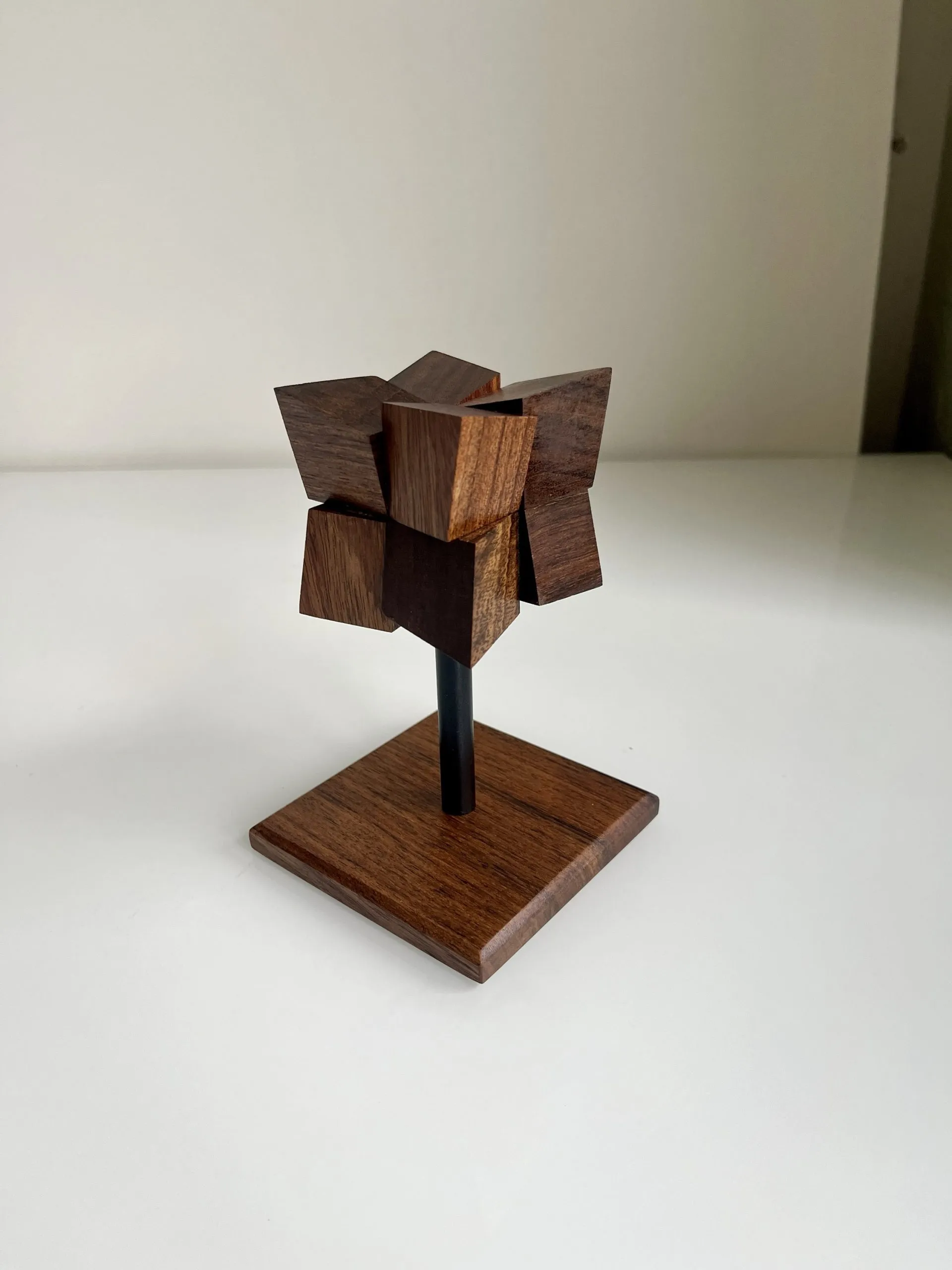 Tall teak Echinus sculpture bristling with fine ridges on a square base